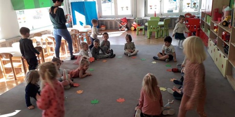 Powiększ grafikę: Dzieci podczas wspólnej zabawy z zastosowaniem liści.